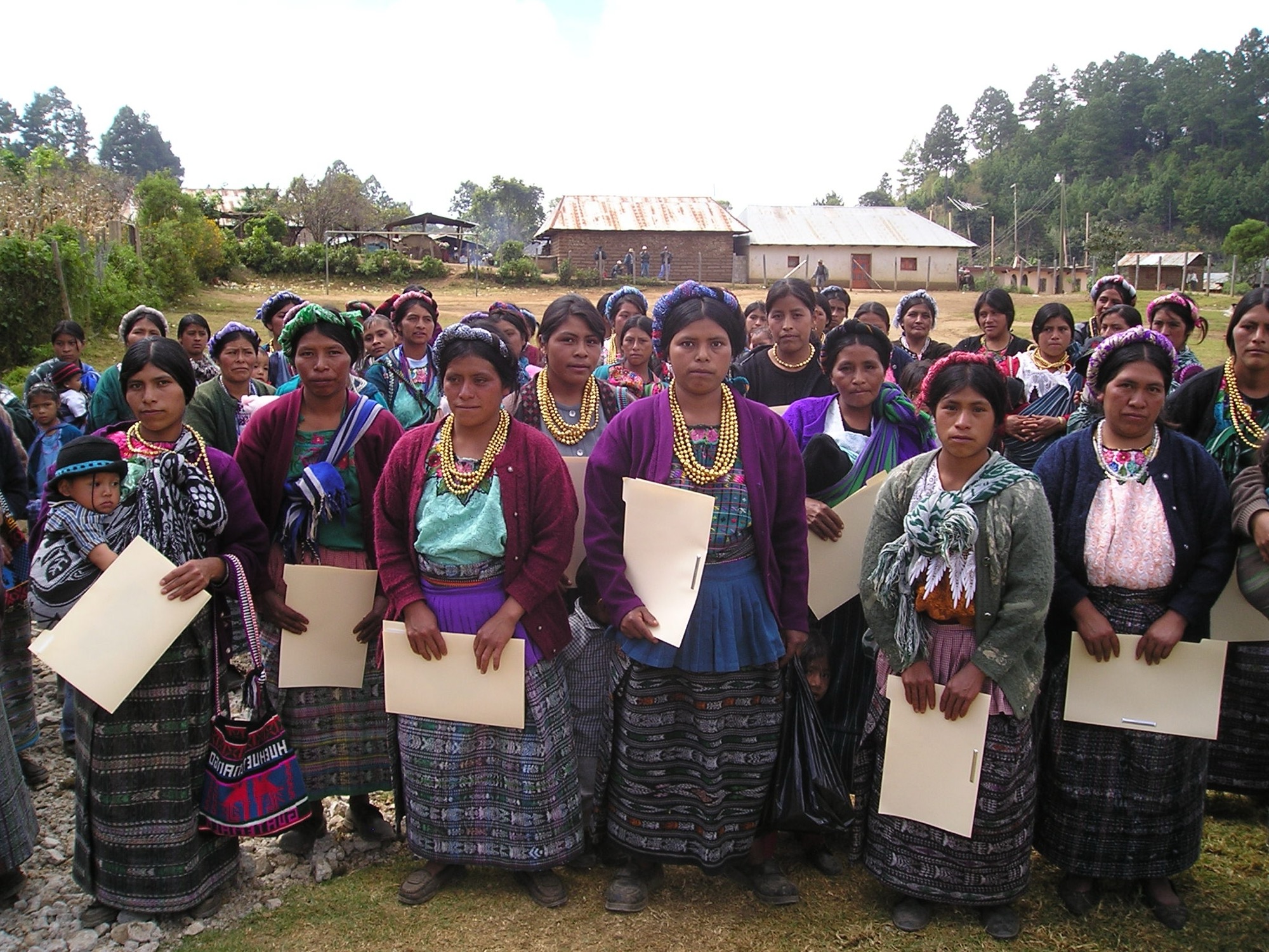 Community health volunteers in Calhuitz, Guatemala, holding their training folders